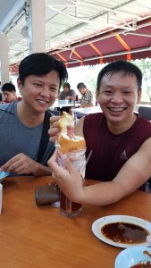 friends enjoying the hotdog bun by sin chew confectinery
